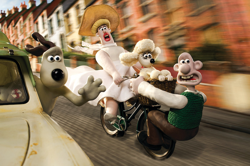 Gromit and Wallace race along a lovely street in a hectic manner..