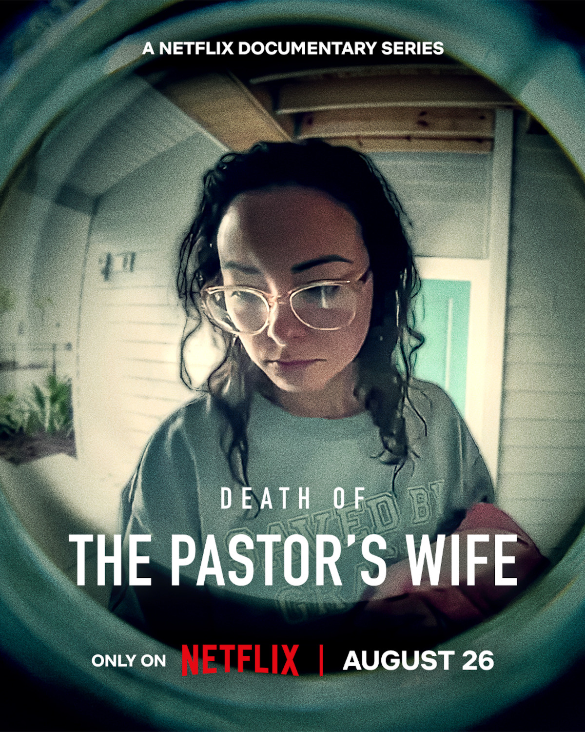 A woman with glasses stands on a house porch, seen through a door's peephole. Text promotes "Death of the Pastor's Wife," a Netflix documentary series premiering August 26.