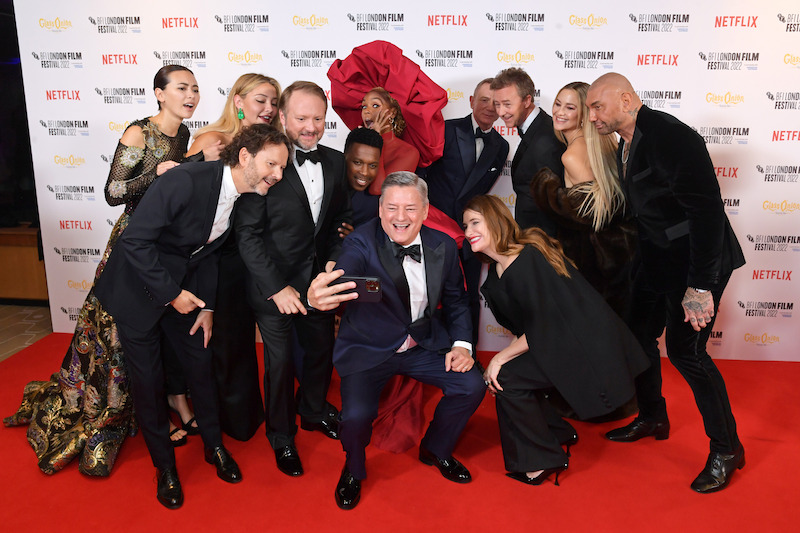From left: Jessica Henwick, Madelyn Cline, Ram Bergman, Rian Johnson, Leslie Odom Jr., Janelle Monae, Netflix Co-CEO Ted Sarandos, Kathryn Hahn, Daniel Craig, Edward Norton, Kate Hudson and Dave Bautista