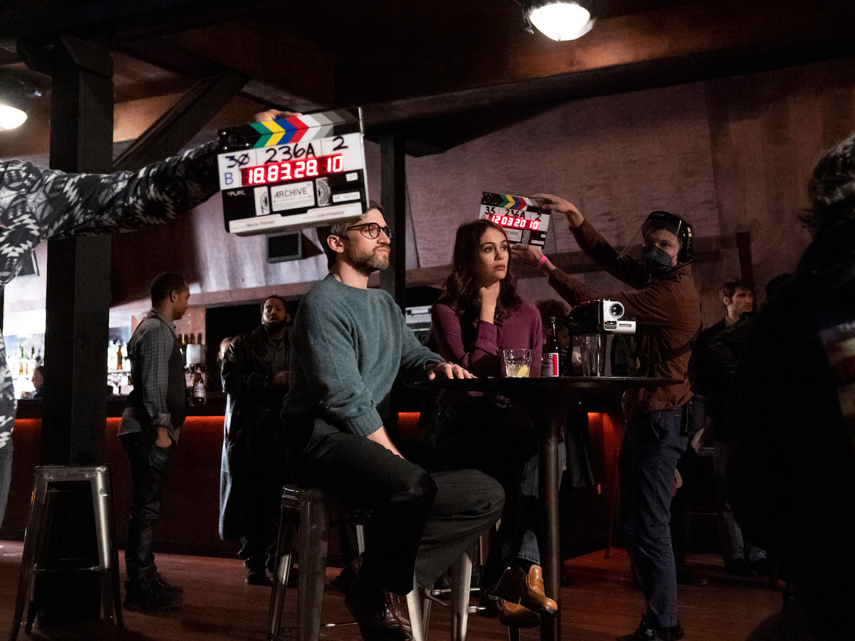 Melody and Samuel are sitting at a venue listening to experimental opera music in 'Archive 81'