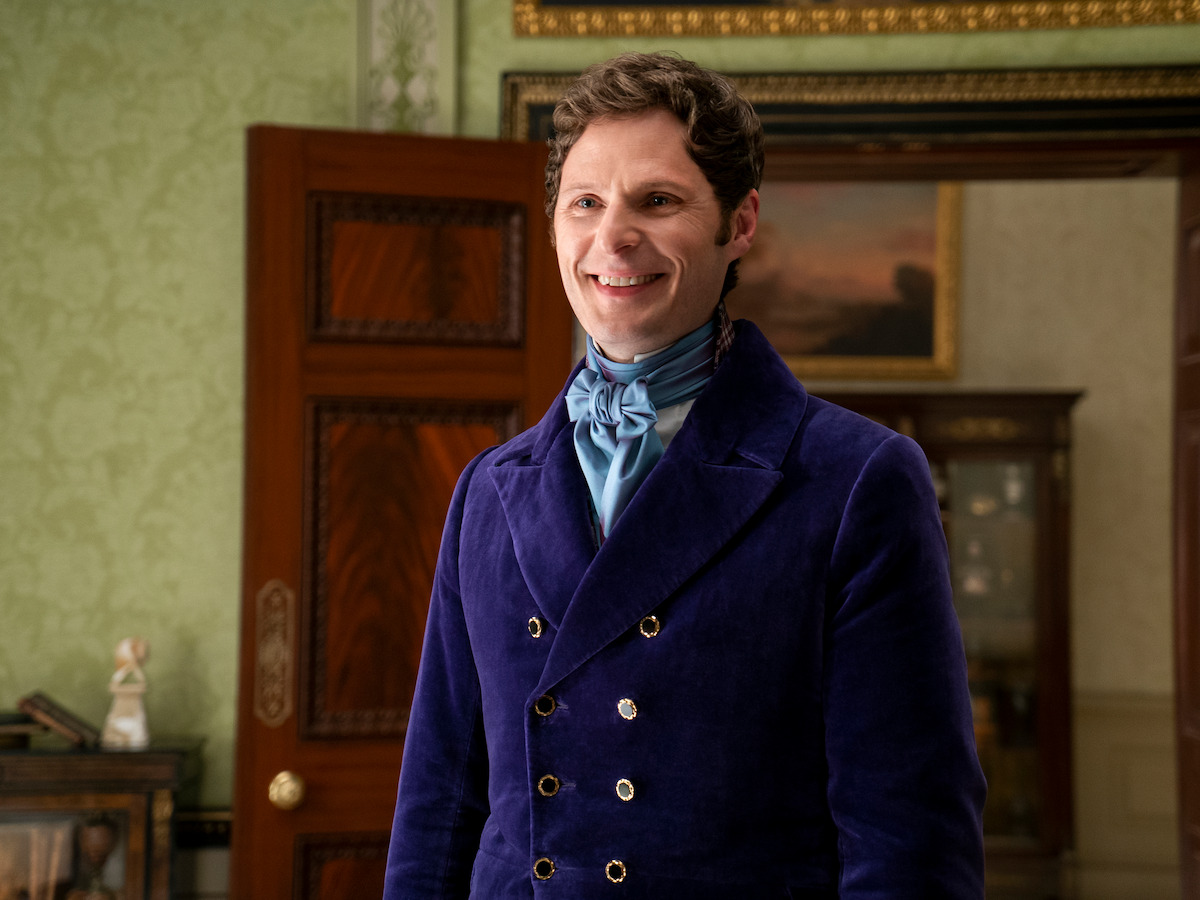 Jack smiles, wearing a blue jacket and shirt.