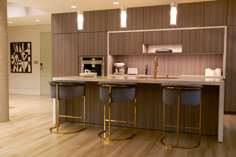 Sleek kitchen land and barstools.