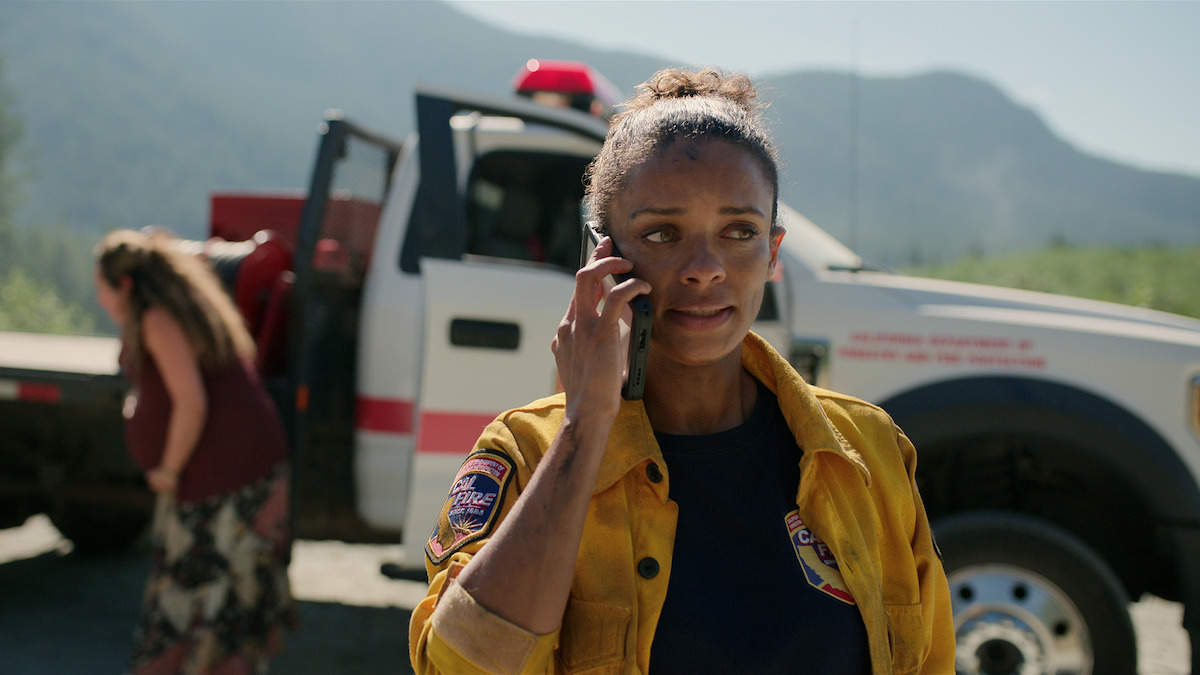 Kandyse McClure as Kaia wears her firefighter’s uniform and takes a phone call in Season 5 of ‘Virgin River.’