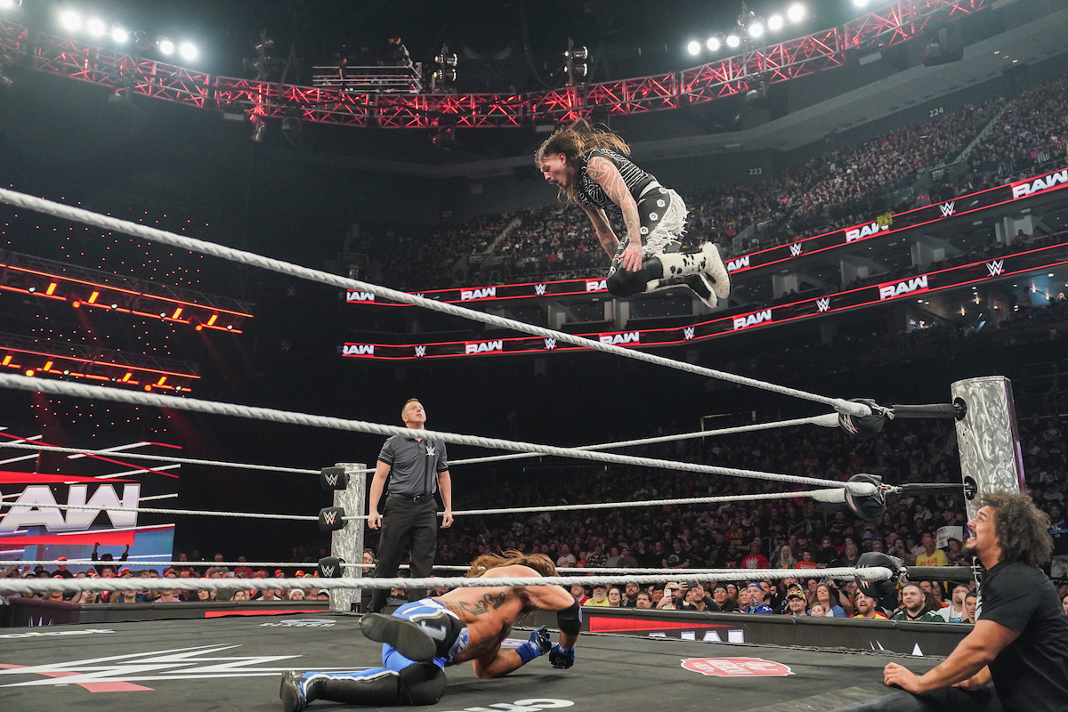 Dominik Mysterio dives into the ring against AJ Styles at WWE Raw