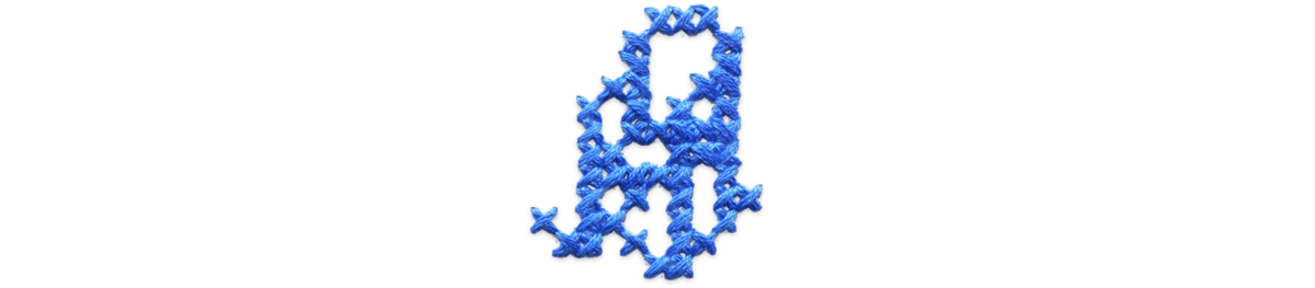Blue cross stitched rocking chair.