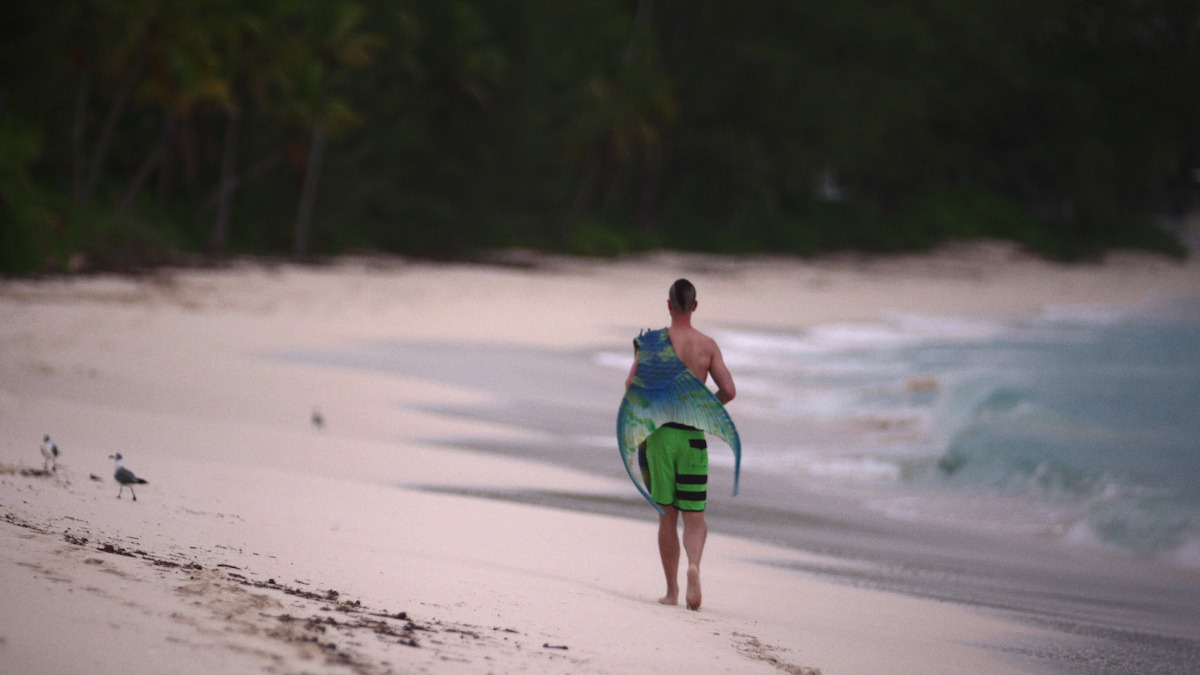 Eric Ducharme walking along the beach in ‘MerPeople.’
