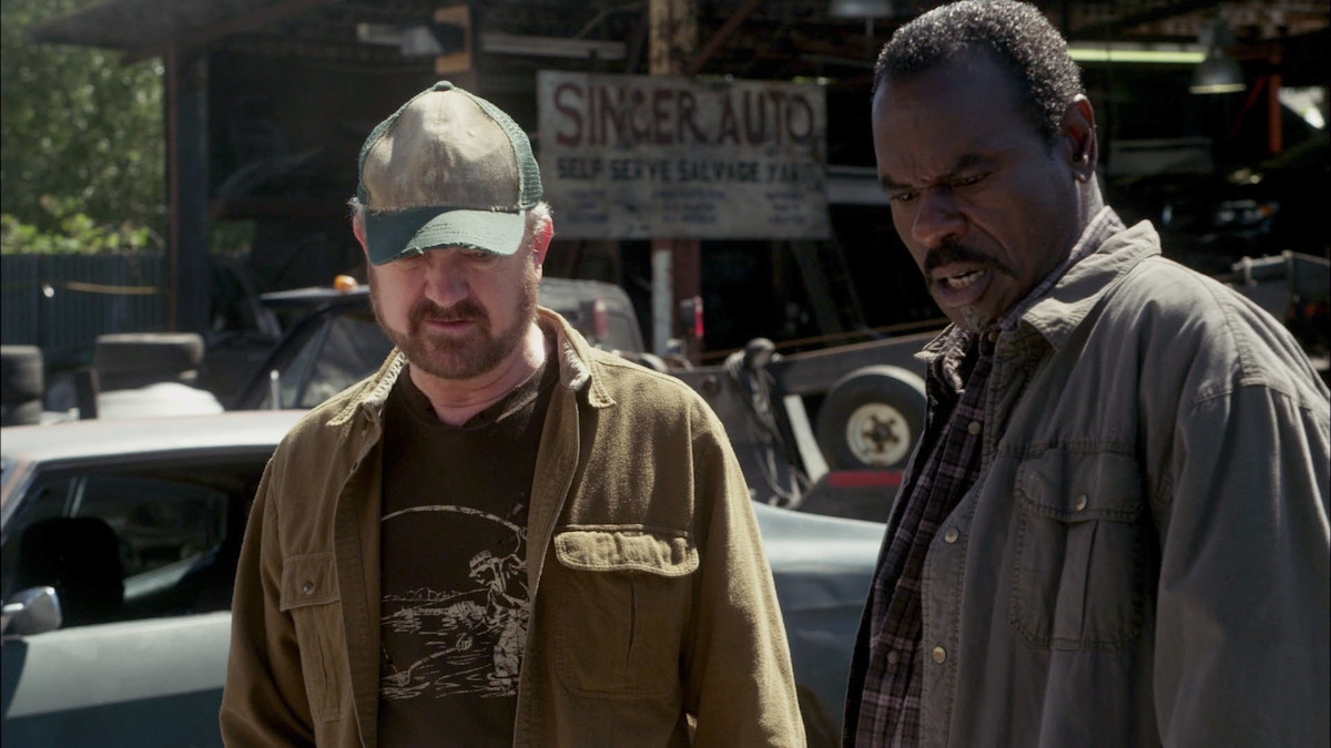 2 Men staring at something on the ground