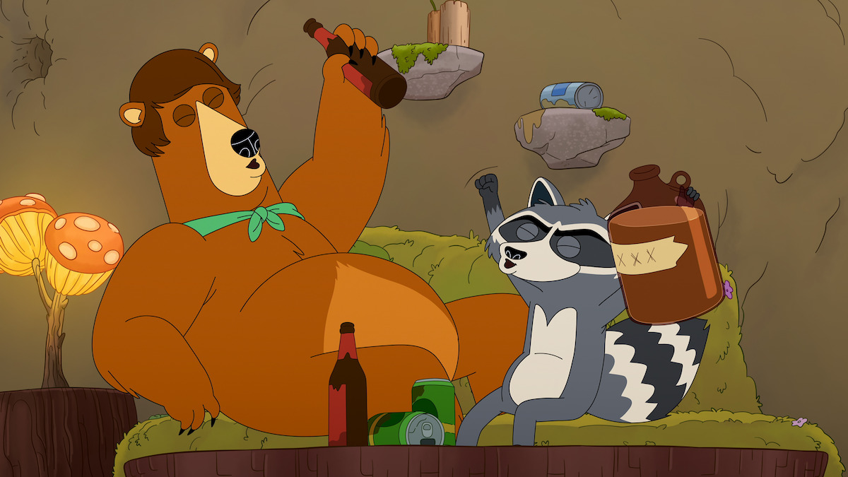 A cartoon bear and raccoon sit on a mossy couch in a cave, surrounded by bottles and jugs, appearing to celebrate or party. The environment includes glowing mushrooms and scattered empty containers.