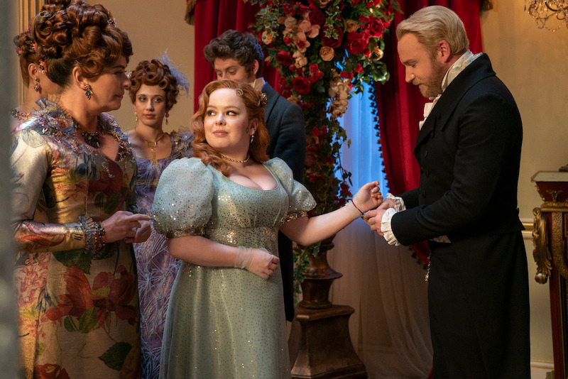 Polly Walker as Lady Portia Featherington, Harriet Cains as Philipa Featherington, Nicola Coughlan as Penelope Featherington, and Sam Phillips as Lord Debling gather at a ball in season 3 of 'Bridgerton'