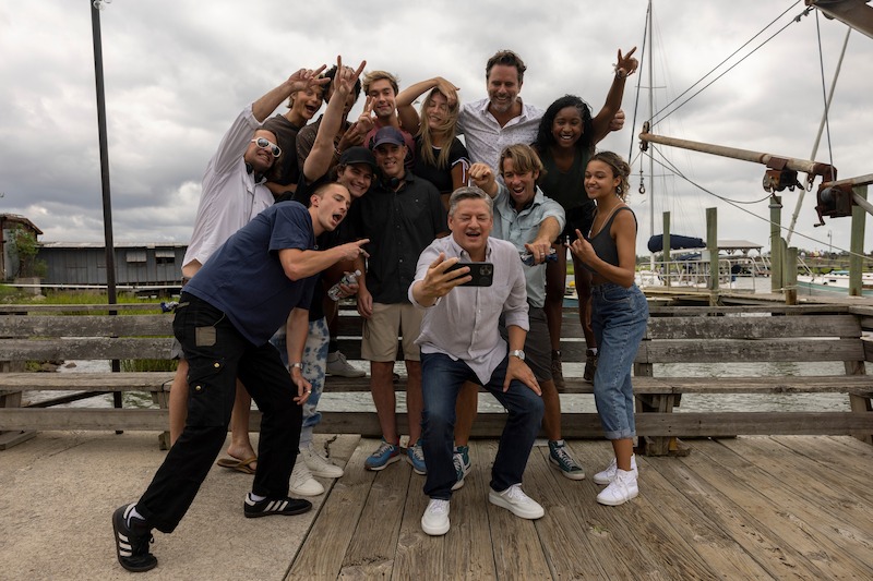 Rudy Pankow, Austin North, Madelyn Cline, Charles Esten, Carlacia Grant, Drew Starkey, Jonathan Daviss, Chase Stokes, Director Jonas Pate, Ted Sarandos and Madison Bailey in Outer Banks Season 3 Behind-the-Scenes Photo Gallery