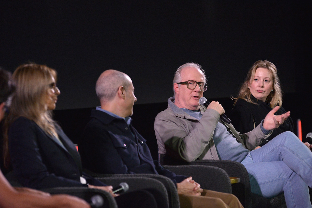 Tracy Letts holds a microphone as he gestures and speaks.
