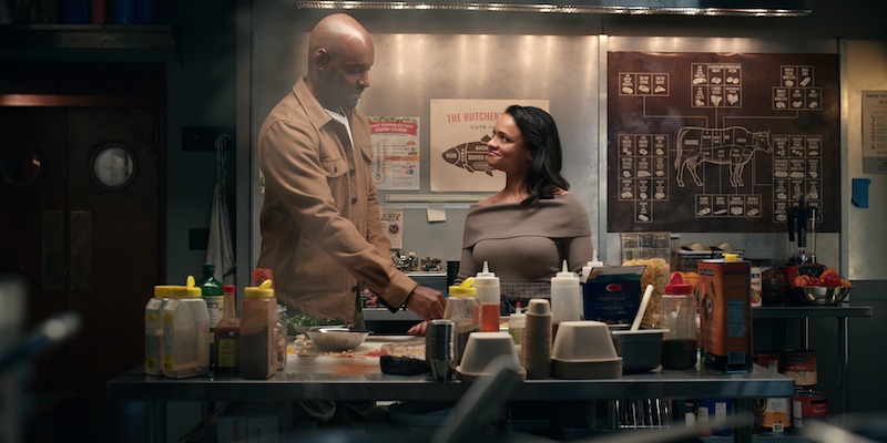 Colin Lawrence as Preacher and Kandyse McClure as Kaia cook in a restaurant kitchen together in Season 6 of 'Virgin River'