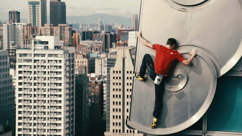 A man scales a tall building.