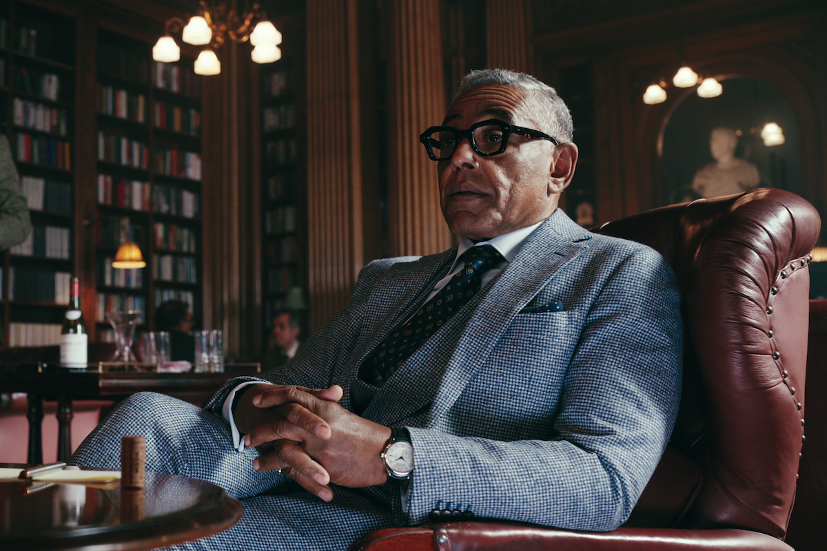 Giancarlo Esposito as Uncle Stan sits on a red leather chair in a library in Season 1 of ‘The Gentlemen’