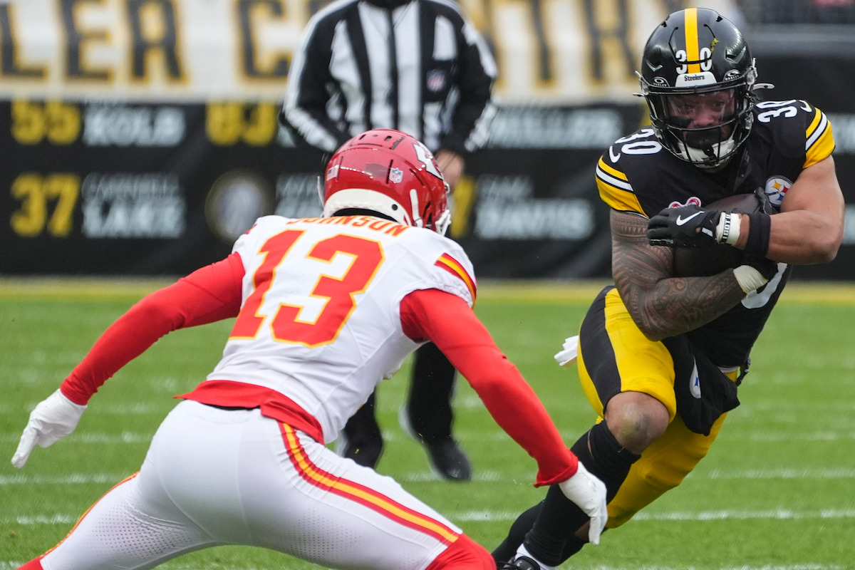 Pittsburgh Steelers running back Jaylen Warren (30) runs against Kansas City Chiefs safety Nazeeh Johnson (13) during the first half of an NFL football game, Wednesday, Dec. 25, 2024, in Pittsburgh.