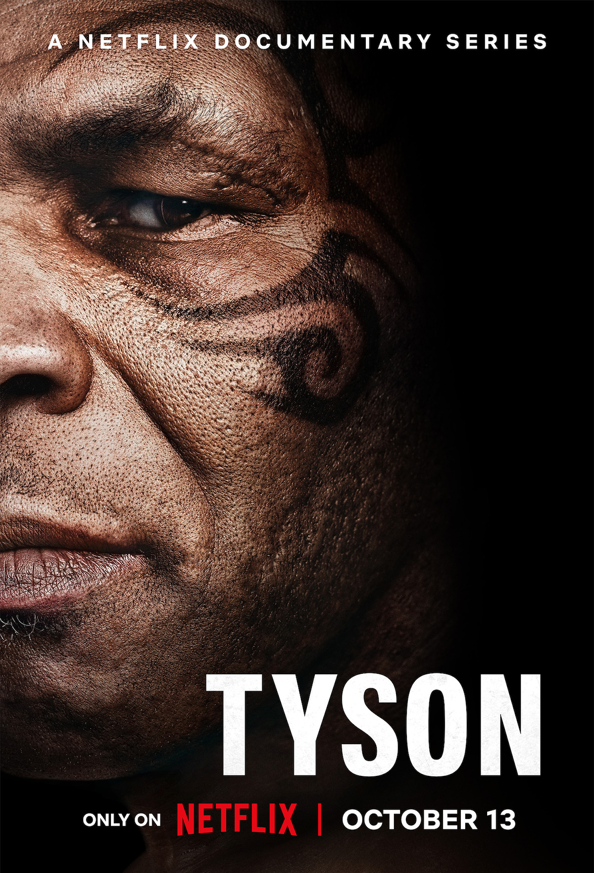 Close-up of a man's face with a facial tattoo, promotional poster for a Netflix documentary series titled "Tyson," releasing October 13.