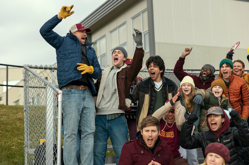 Blucas as George, Stanhope as Danny, Myles Perez as Lee, Alix West Lefler as Parker, Lennix James as Benny, and Dean Petriw as Jordan cheering at an outdoor event in 'My Life with the Walter Boys' Season 2