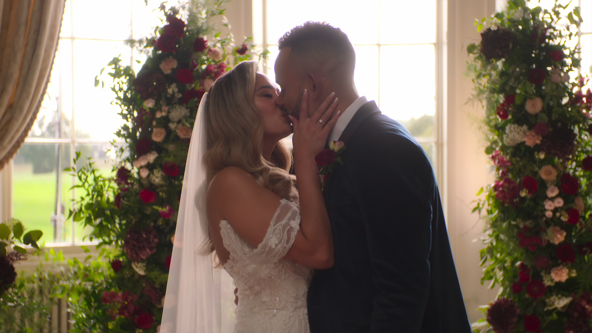 Jasmine and Bobby kiss at the altar.