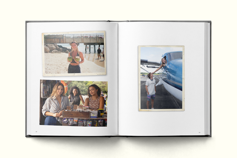Photo album open to four young women: one holding a coconut on a beach, two at an indoor market, one posing with a plane on an airport tarmac. Each scene captures diverse travel settings and relaxed, happy moments.