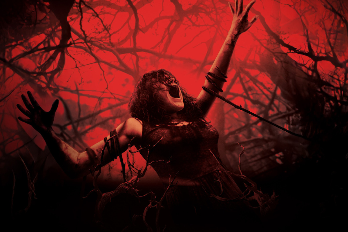 A woman screaming with arms raised, entangled in dark branches, in a haunted forest with a dramatic red and black background, evoking a scene of horror and supernatural tension.