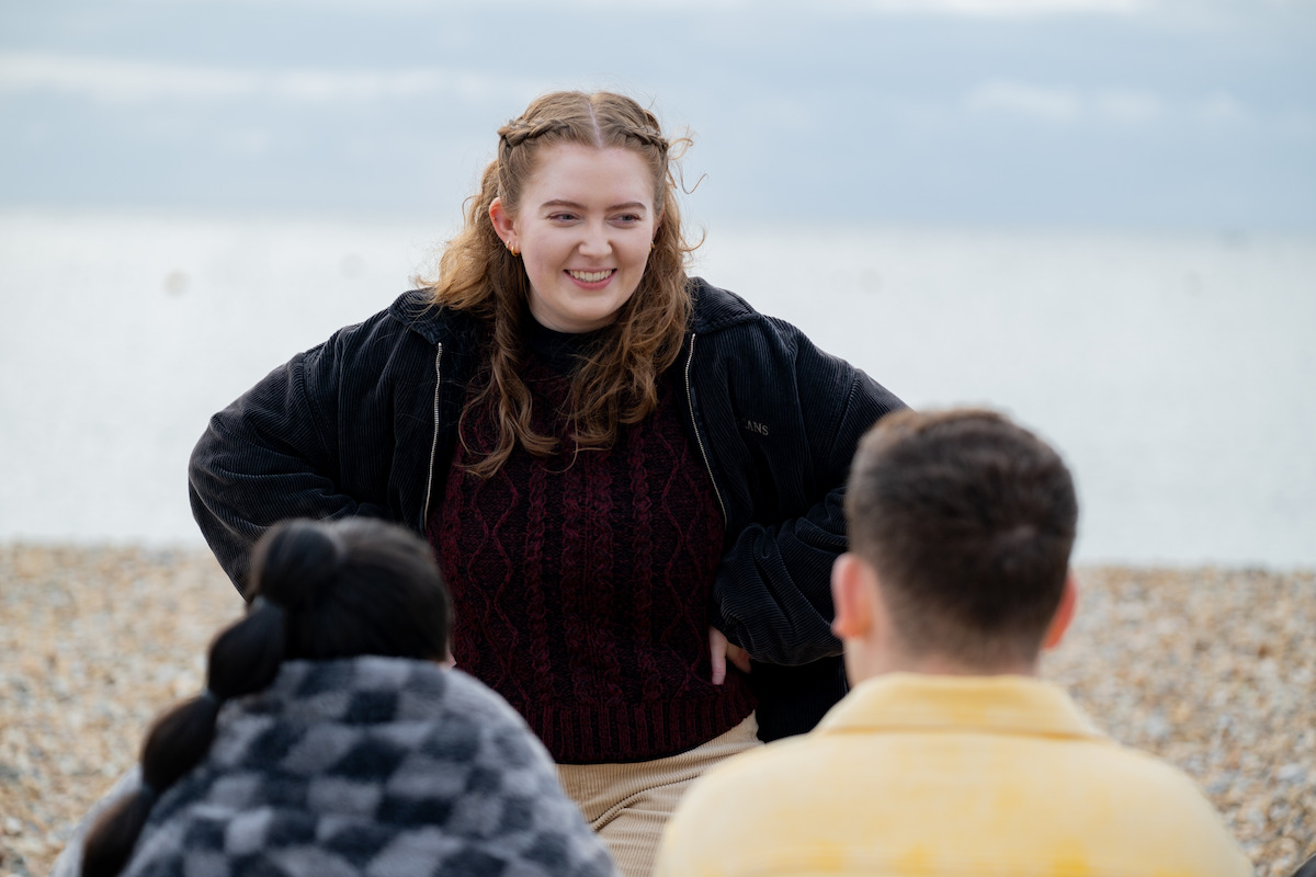 Behind the scenes image of Alice Oseman working with cast on the set of Season 3 of ‘Heartstopper’