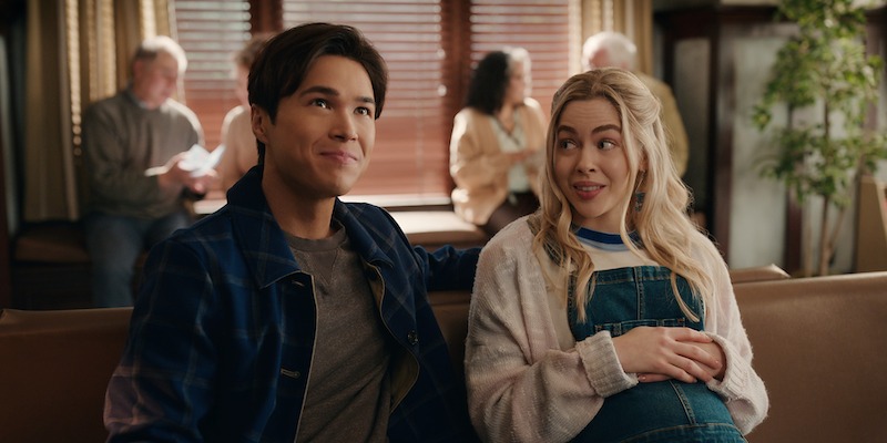 Kai Bradbury as Denny Cutler and Sarah Dugdale as Lizzie sit at a cafe together in Season 6 of 'Virgin River'