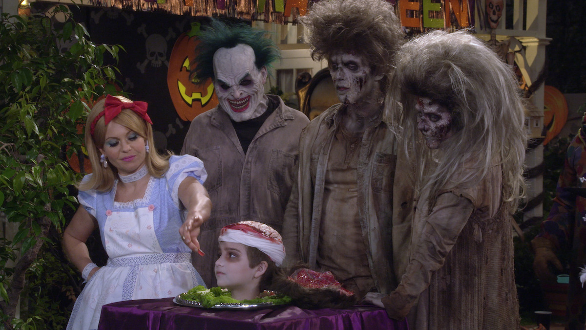 Trick or treaters that include, Alice in wonderland, a head on a table, a Joker and two zombies. 