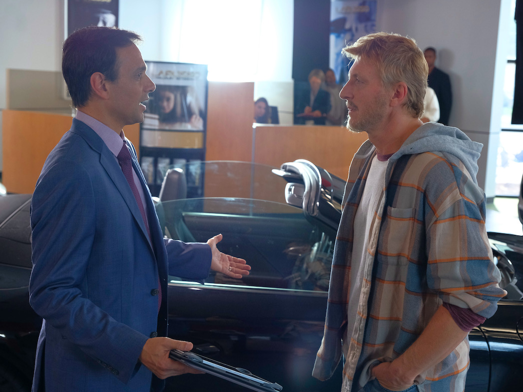 Daniel and Johnny talk at the car dealership
