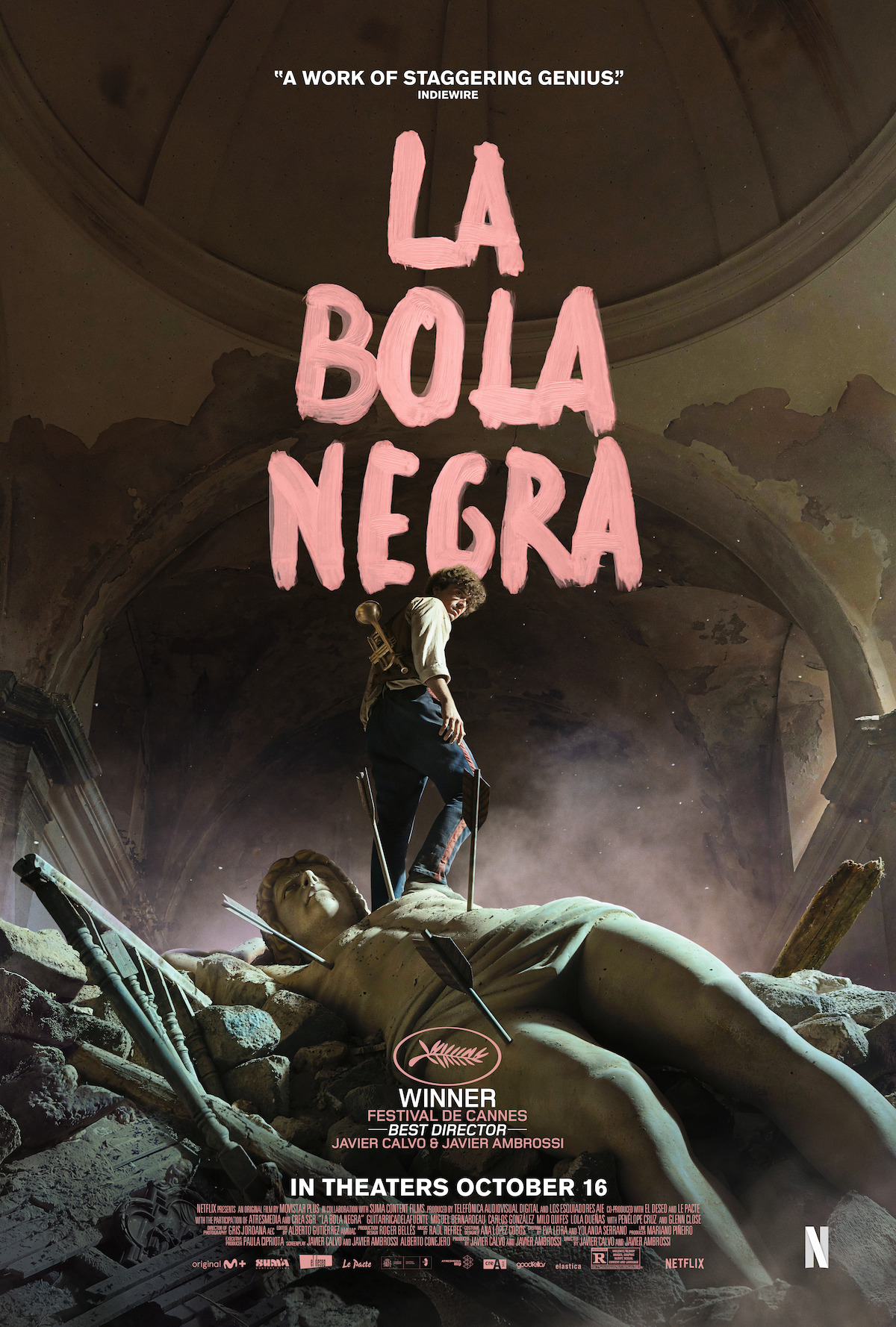 A dramatic movie poster shows a man standing amidst ruins inside a grand, decaying building, with a broken statue in the foreground and large pink text reading "La Bola Negra" above. The lighting is moody and cinematic.