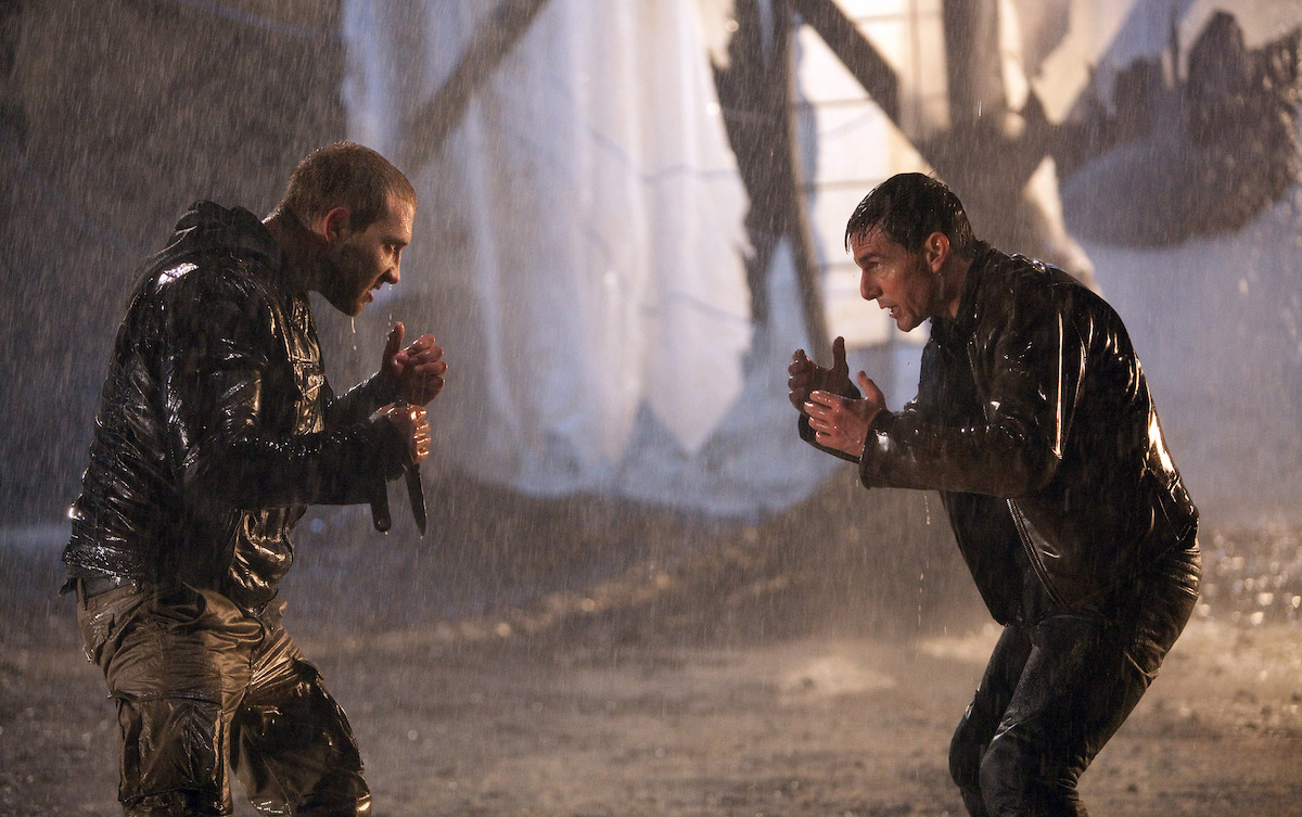 Jai Courtney as Charlie and Tom Cruise as Jack Reacher face off in the rain in an image from the film ‘Jack Reacher.’