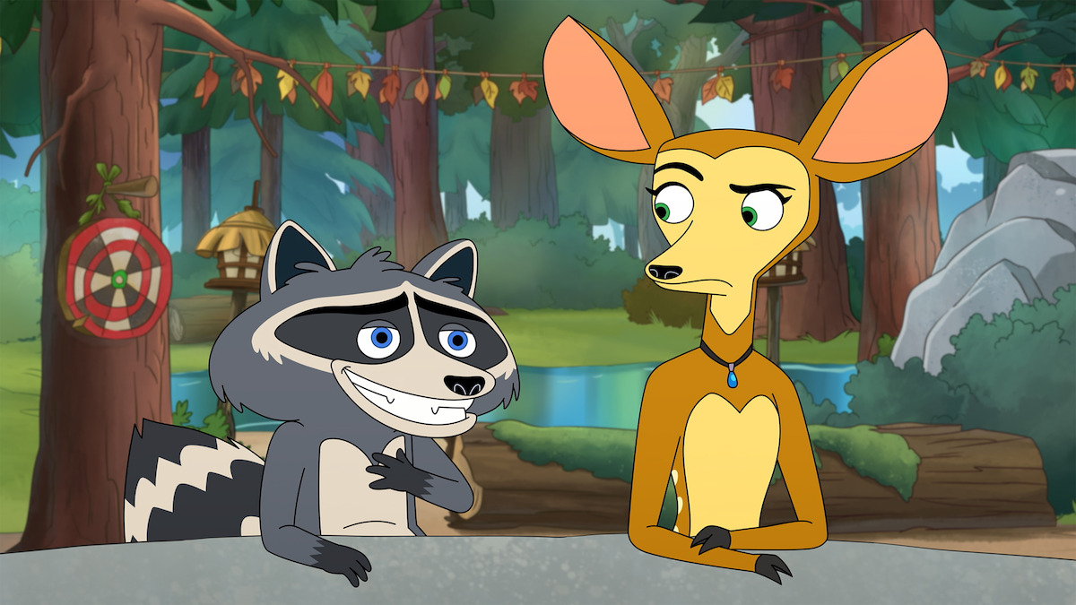A cartoon raccoon and deer sit at a table in a colorful forest camp setting, with trees, a lake, target practice board, and wooden cabins in the background, both displaying expressive emotions.