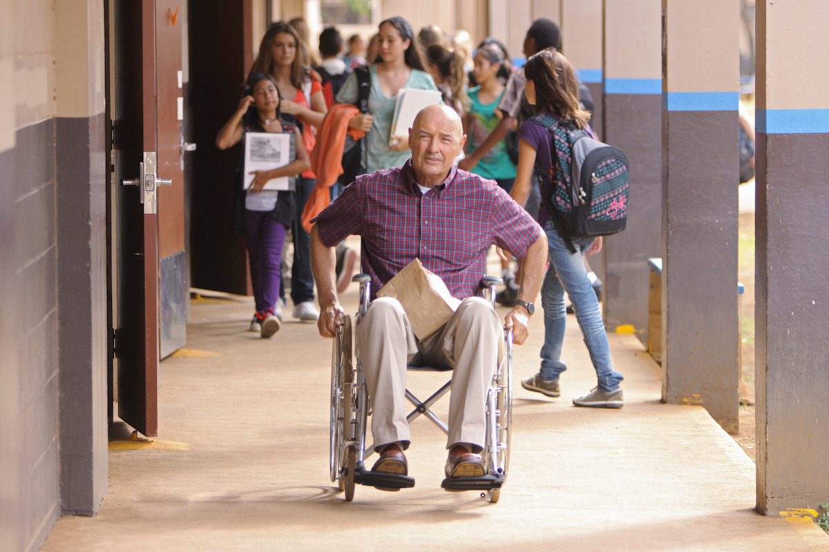 Terry O'Quinn in a wheelchair at a school.
