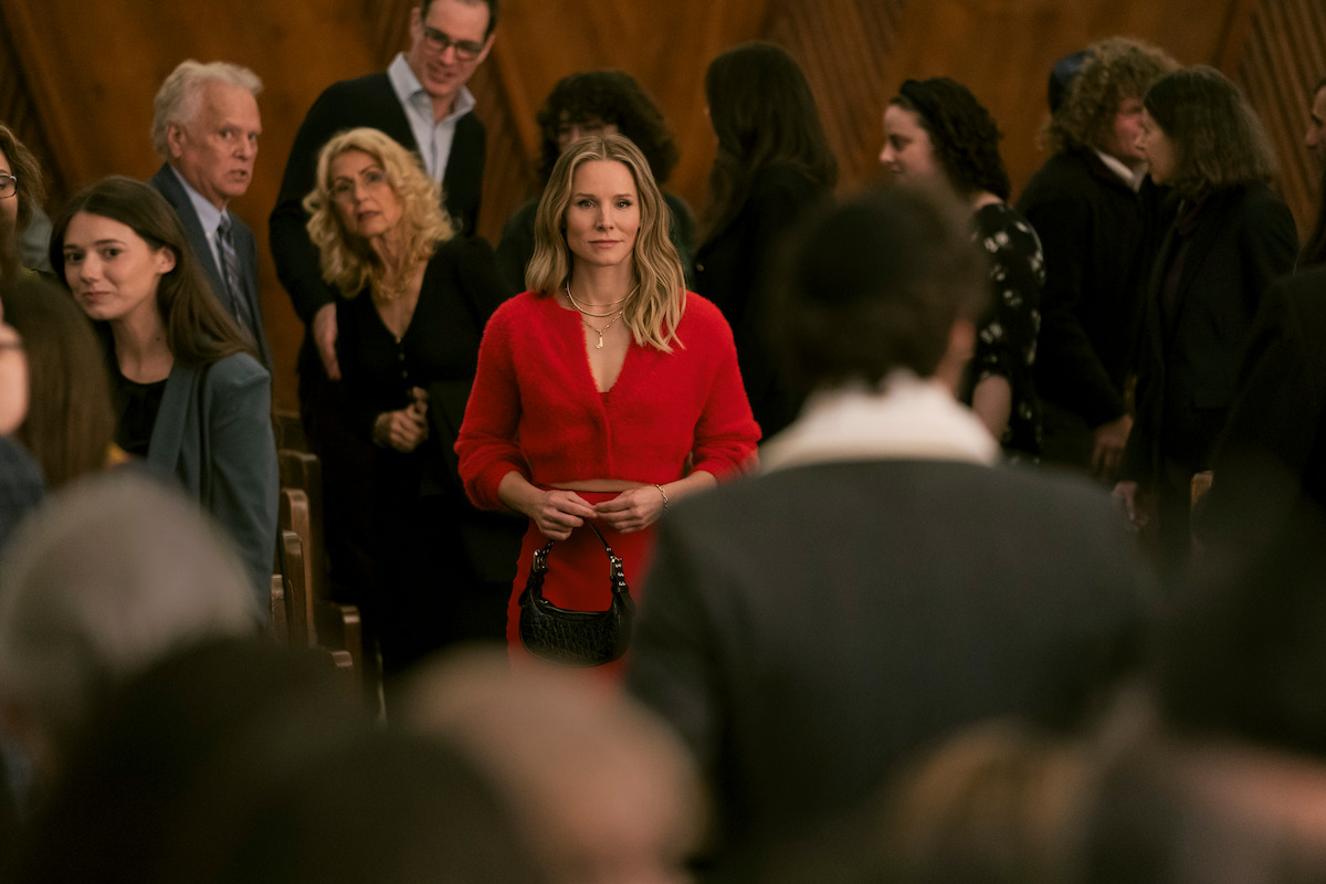 Kristen Bell as Joanne stands in a synagogue wearing a red outfit in Season 1 of ‘Nobody Wants This.’