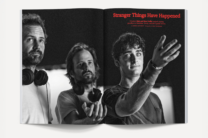 Three men stand together in a black and white magazine spread, two wearing headphones around their necks. One man extends his hand forward. Text above reads "Stranger Things Have Happened" in a studio-like setting.