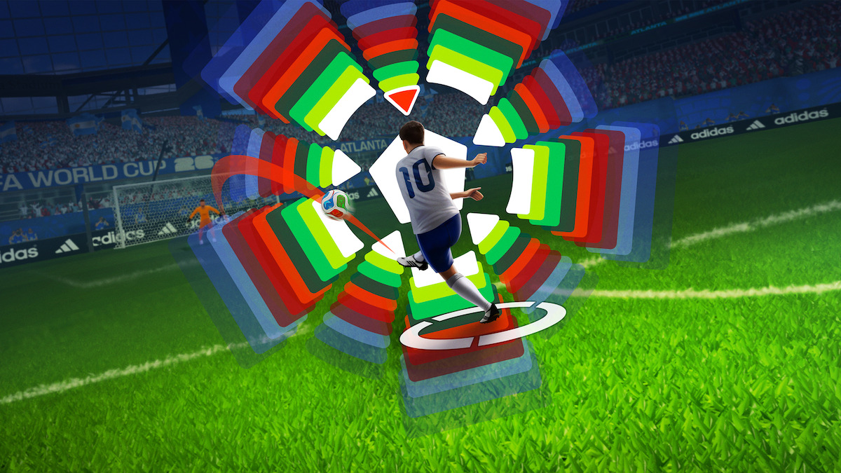 Soccer player in white jersey taking a shot on goal in a stadium, with colorful digital graphics showing trajectory and power settings, crowd and banners visible in the background.