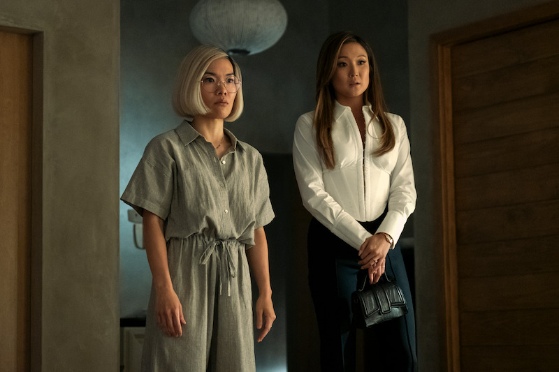 two women standing in a hallway