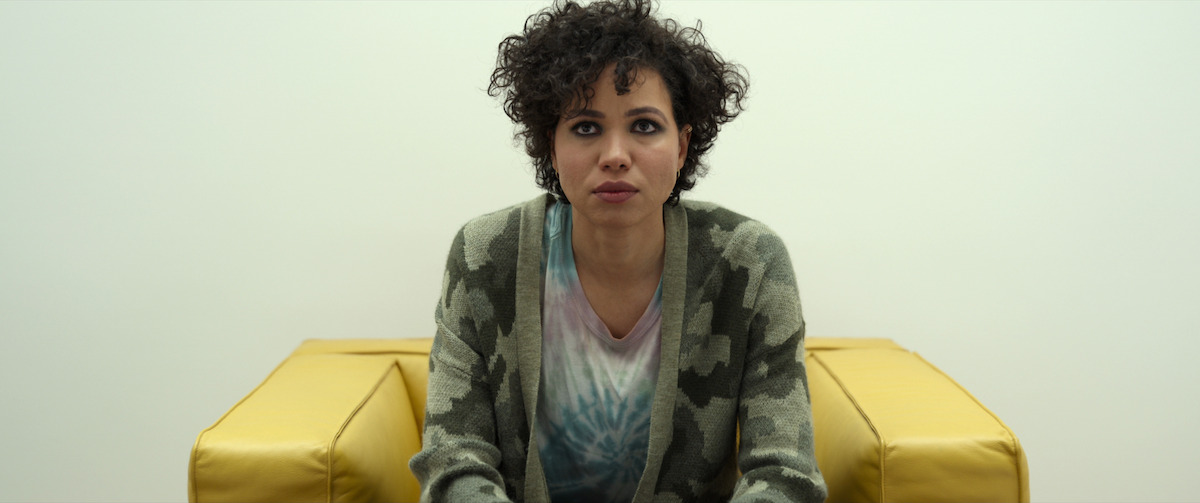 Lizzy (Jurnee Smollett) is interrogated in a Barber Osgerby compact armchair - The Beauty of Brutalism: the Design References in ‘Spiderhead’ Revealed