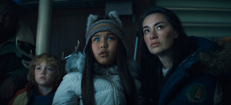 Christian Convery as Gus, Ayazhan Dalabayeva as Nuka,  and Cara Gee as Siana huddle together with fearful expressions in Season 3 of 'Sweet Tooth'