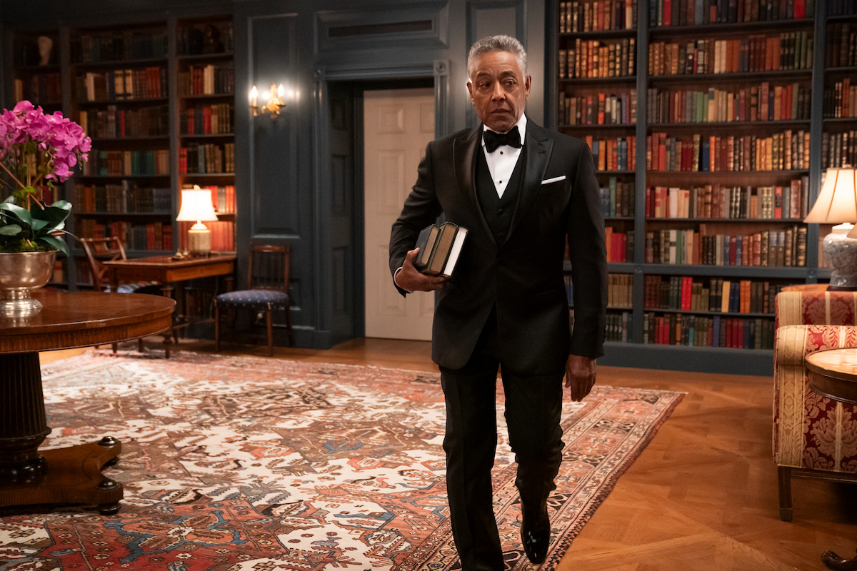 A.B. Wynter walking in the White House Library with books under his arm.