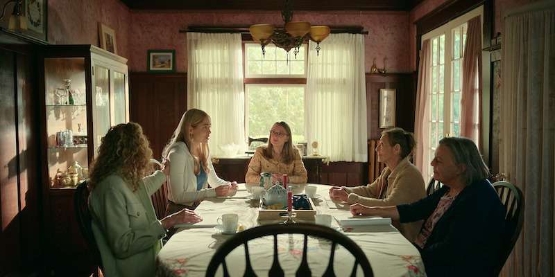 (L to R) Gwynyth Walsh as Jo Ellen, Sarah Dugdale as Lizzie, Annette O’Toole as Hope, Christina Jastrzembska as Lydie, Nicola Cavendish as Connie sitting around a table. 