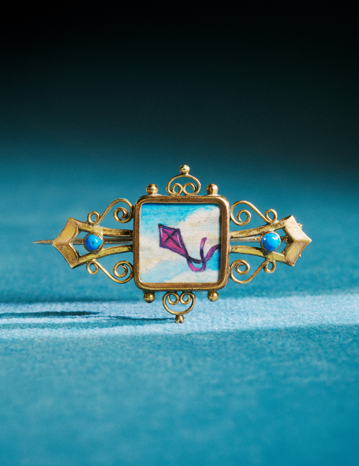 Benedict’s wedding brooch with a kite painted on it