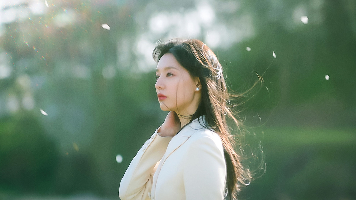 Kim Ji-won as Hong Hae-in stands outside with her hair blowing in the wind in the series ‘Queen of Tears.’