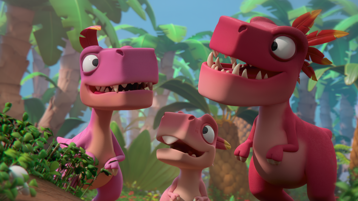 Three animated pink dinosaurs with expressive faces stand together in a lush, colorful jungle environment filled with tropical plants and trees, looking cheerful and curious.