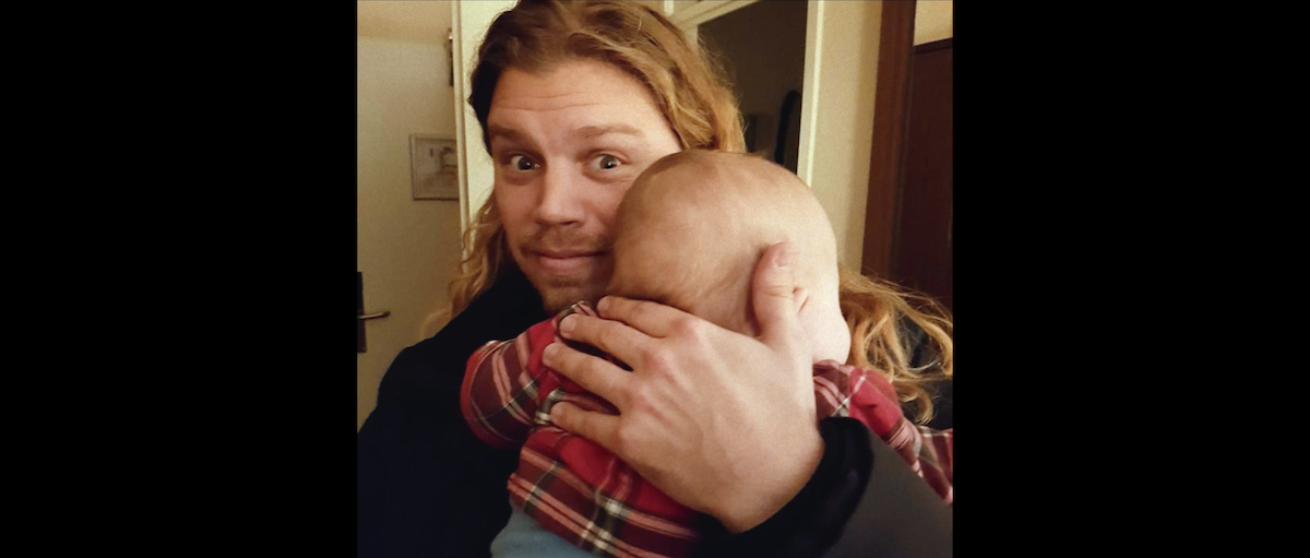 Jonathan Meijer holding a baby.