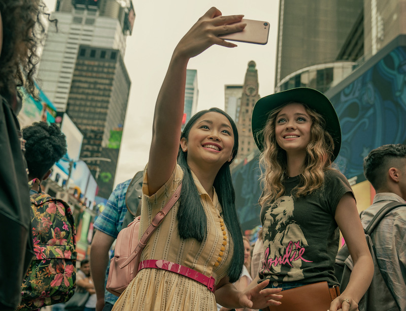 Lana Condor as Lara Jean and Madeleine Arthur as Christine take a selfie on their trip to New York City.