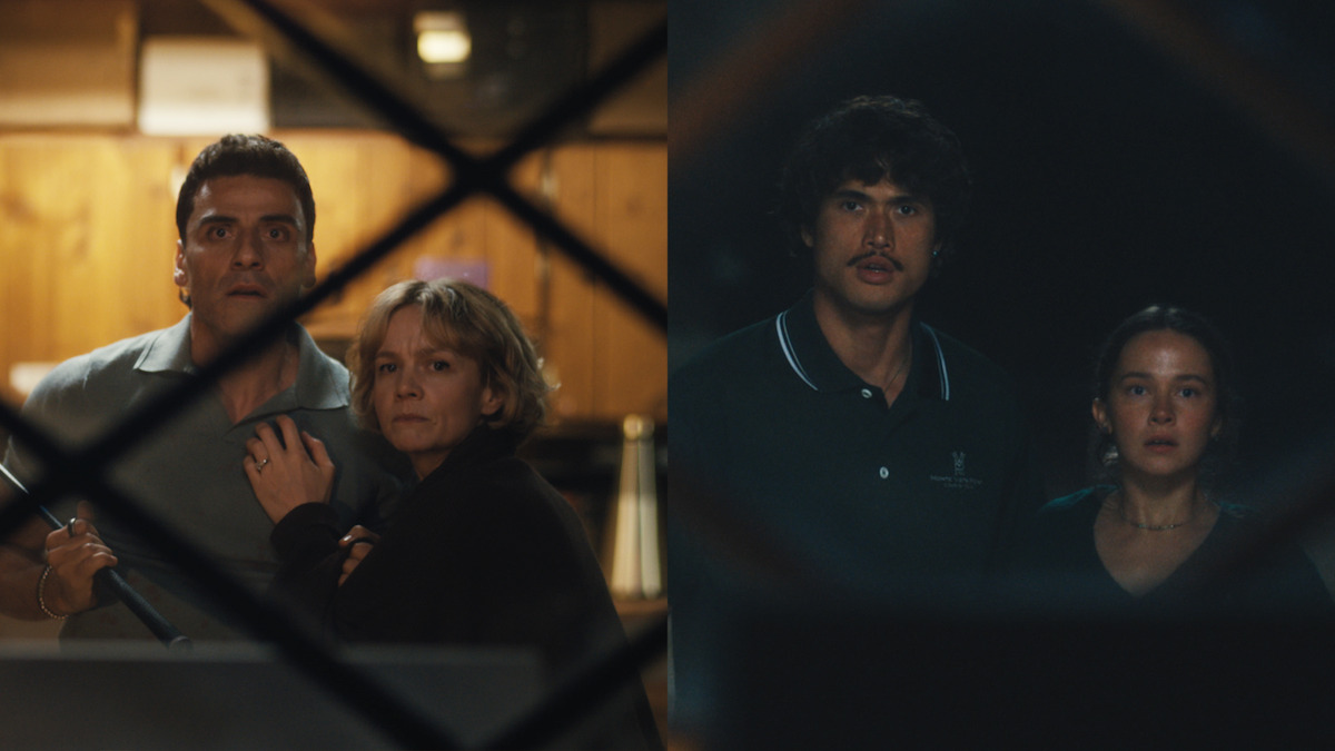 Four people stand indoors behind a window with a grid. On the left, two look tense in a warmly lit wood-paneled room. On the right, two stand close together in dim light, all appearing anxious or concerned by something unseen.