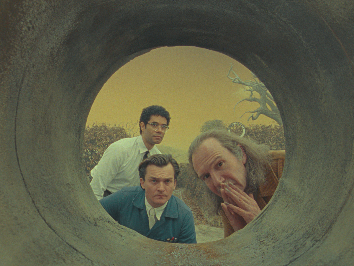 Richard Ayoade, Rupert Friend, and Ralph Fiennes as the Rat Man in a still from ‘The Rat Catcher.’