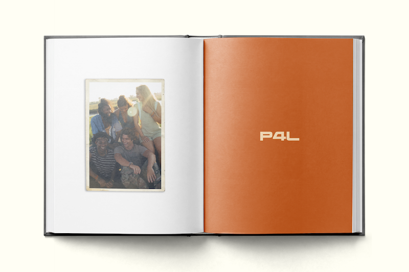A photo book open to a page showing a group of friends outdoors in sunlight, sitting closely and smiling, with an adjacent orange page featuring the text "P4L."