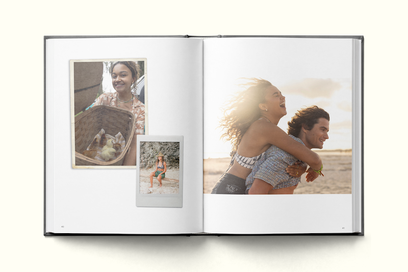 Photo book open to pages with candid travel photos: a woman with a basket and a sloth, a person in swimwear against a stone wall, and a joyful couple on a beach at sunset, capturing vacation memories in natural light.