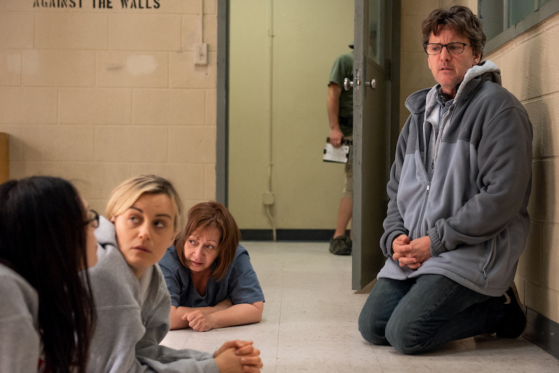 (L to R) Laura Prepon as Alex, Taylor Schilling as Piper, Andrew McCarthy (Director) on the set of Orange Is The New Black Season 5.